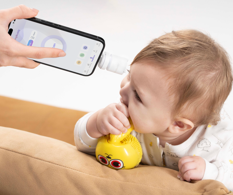 A baby moving while a parent scans their forehead with TempBuddy