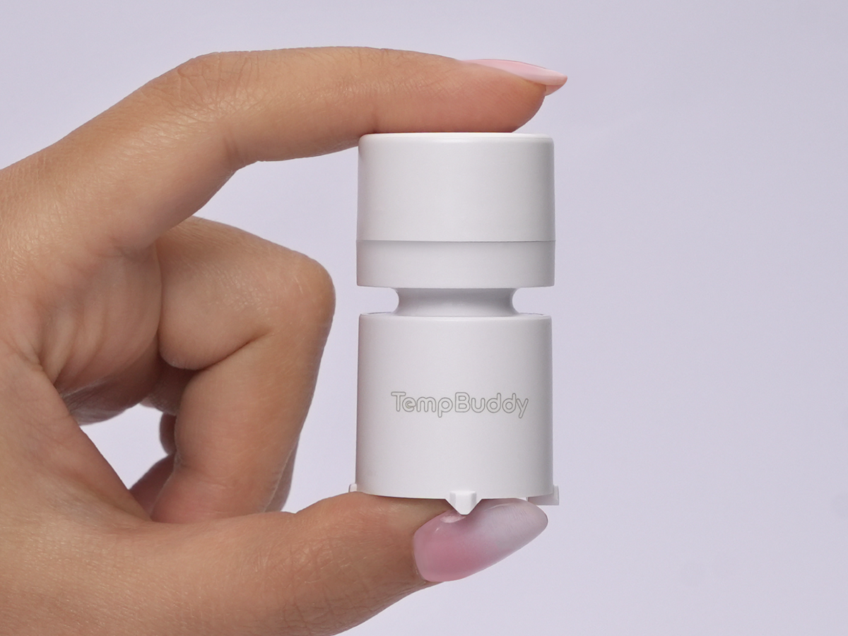 TempBuddy held between finger and thumb, showing how small it is
