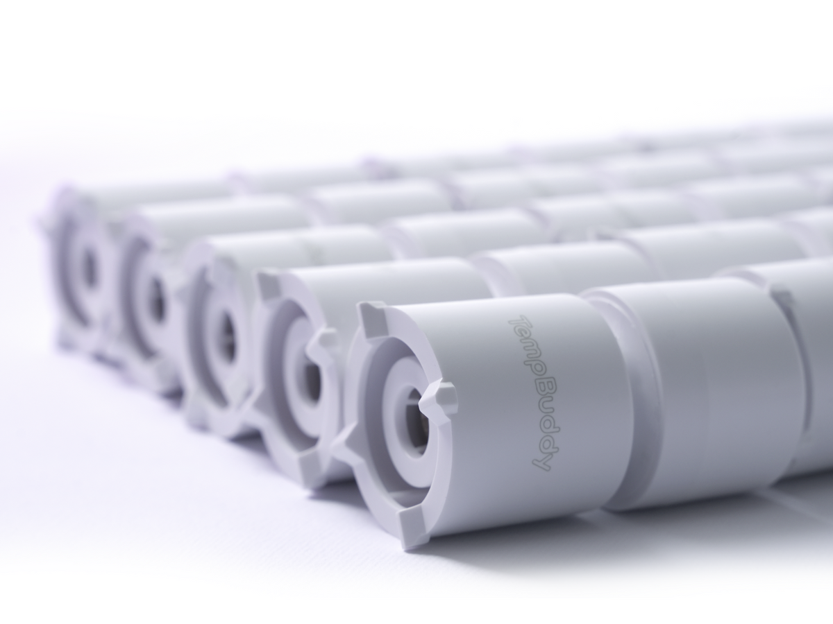 A row of TempBuddy sensor housings on the production line